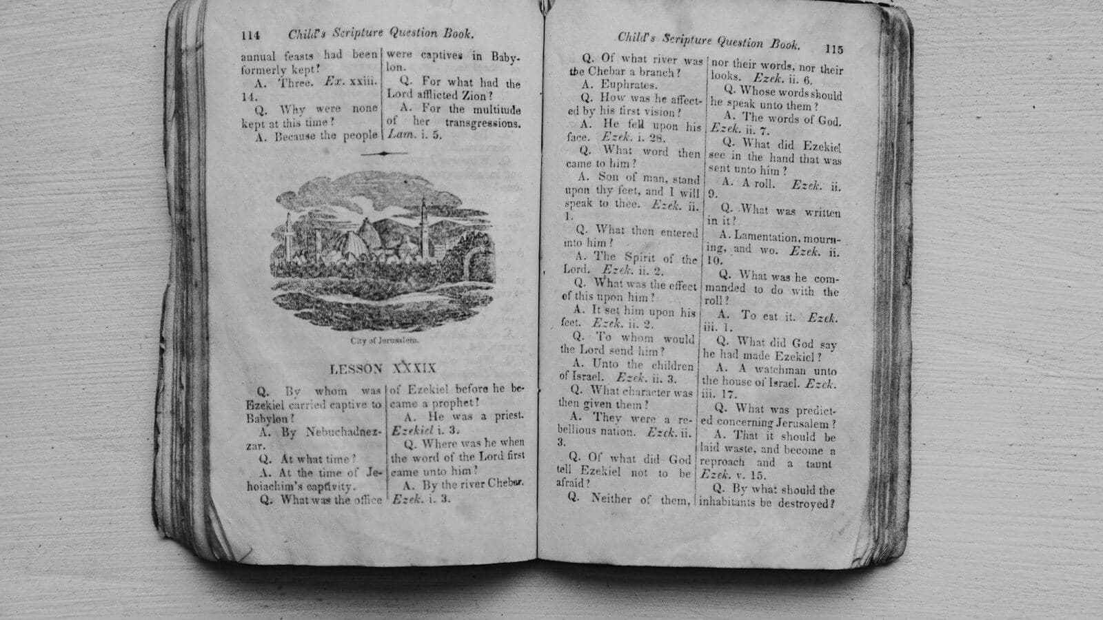 An old open book with an engraving