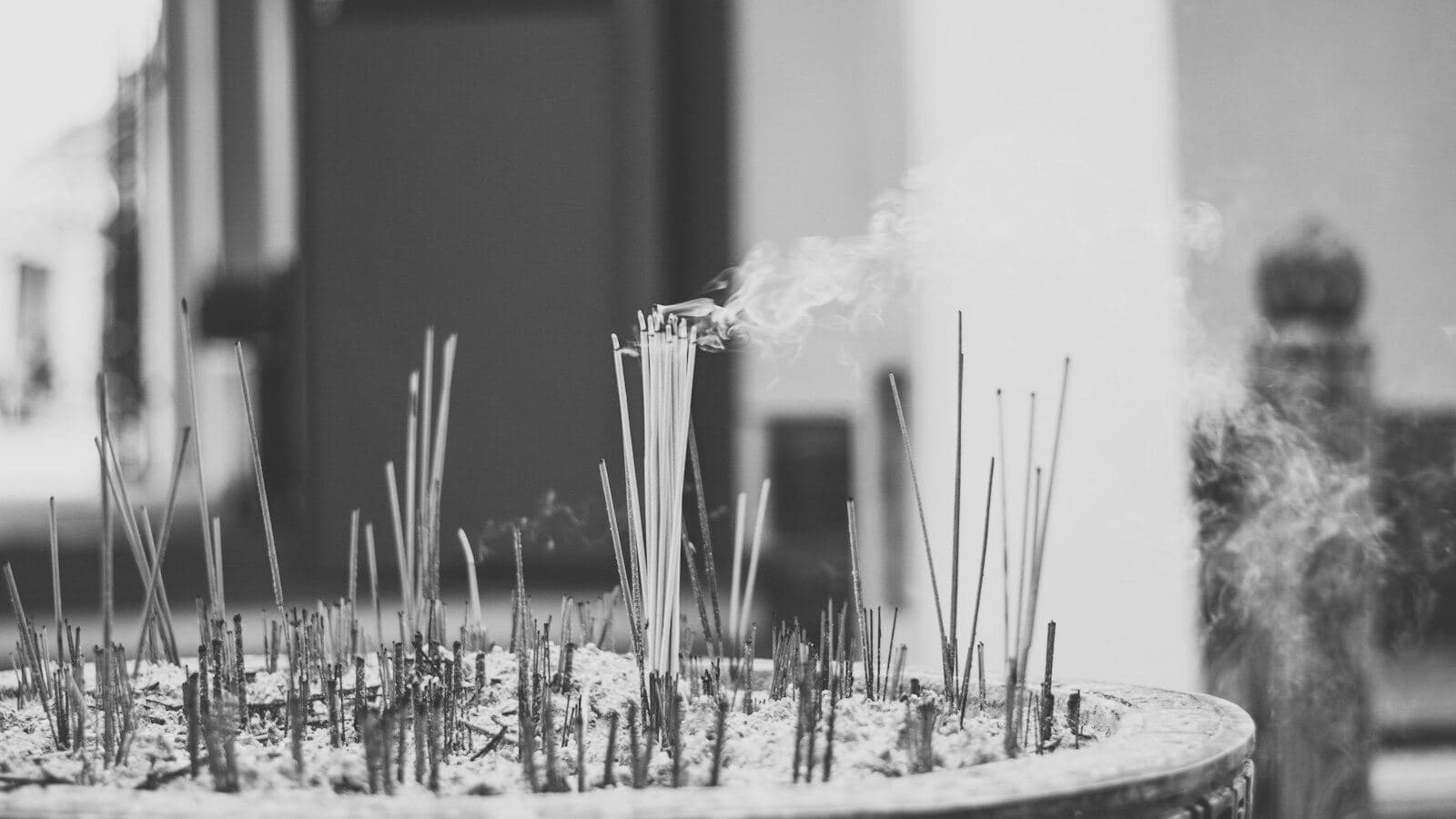 Incense sticks over ash, in a temple