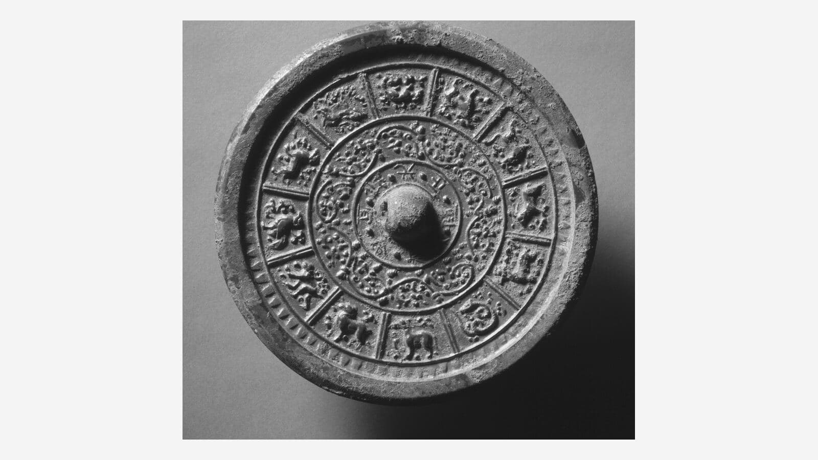 A Chinese bronze mirror with the twelve zodiac animals around it