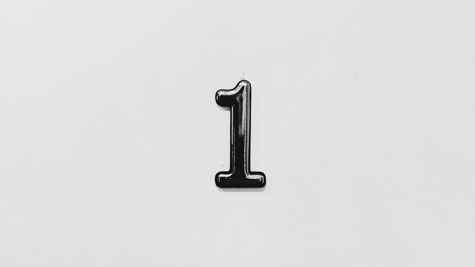 A metal number 1 on a light wall