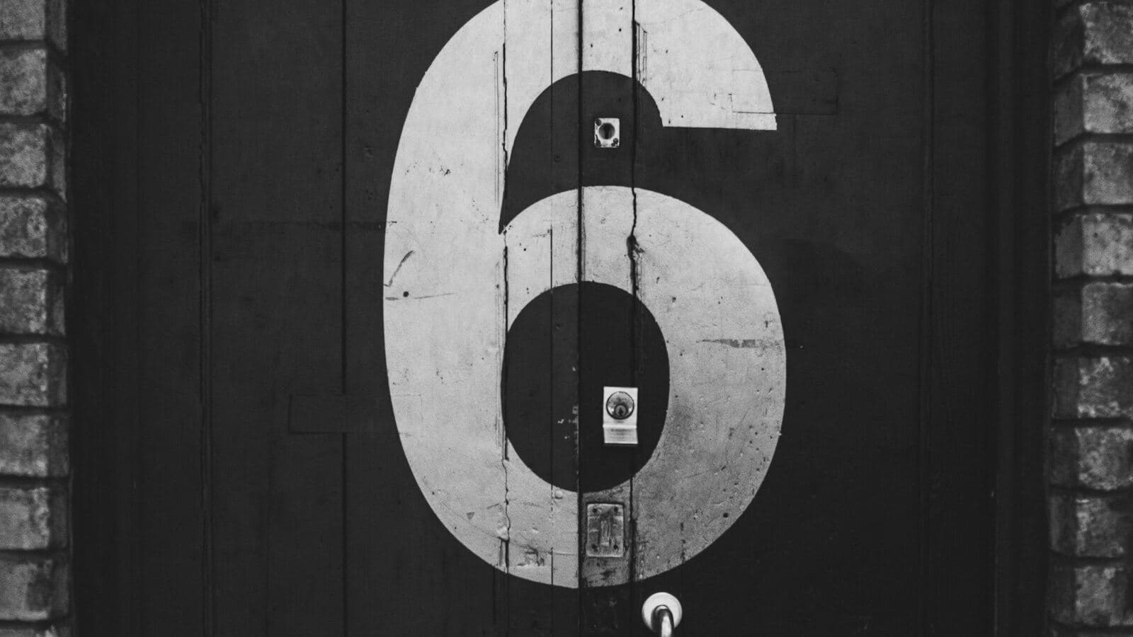 A number 6 painted on a wooden door