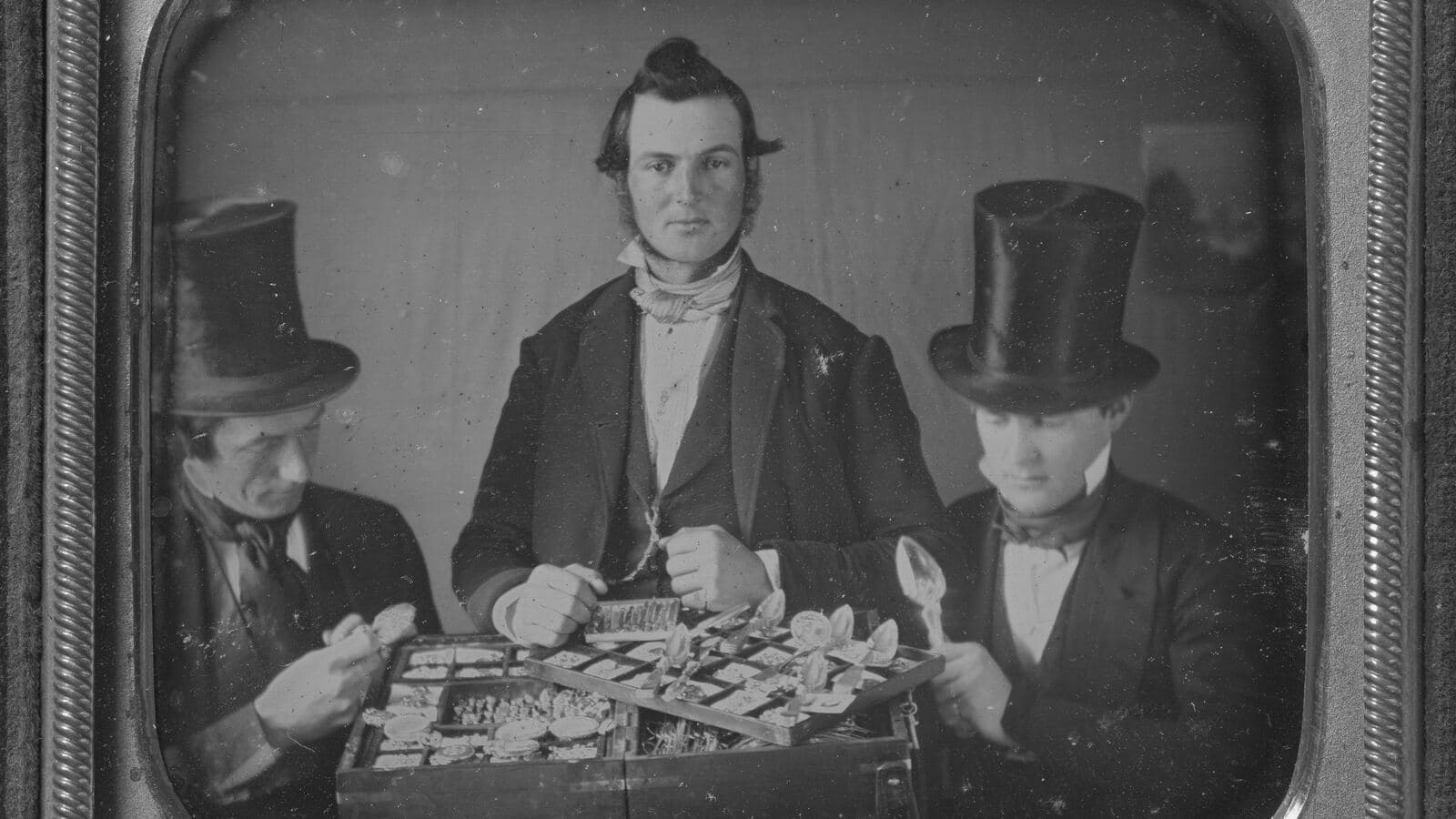 Two silver merchants sitting at a table, daguerreotype from around 1850